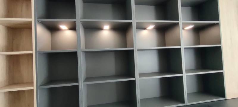 Création d'un espace cave à vin assorti à une cuisine sur mesure blanc mat et profil bronze avec lumières intégrées à Martillac